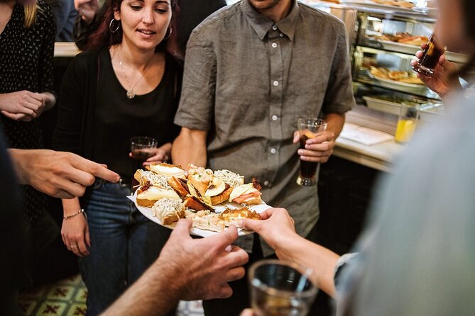 Madrid Evening Tapas and Wine Guided Tour - Stop 3 at Muñiz: historic tavern energy and slow-cooked stew