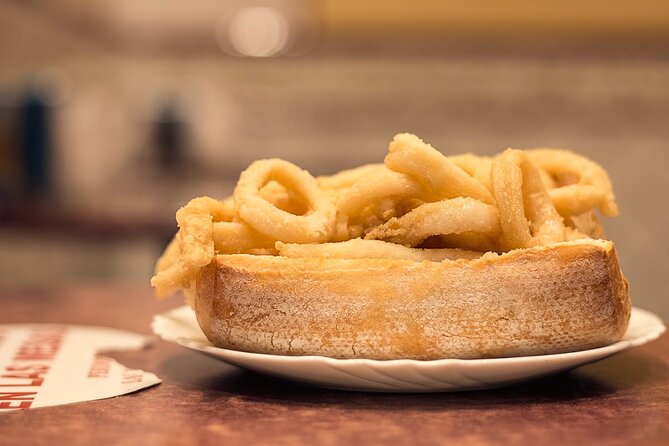 Madrid Historic Centre Food Tour with Authentic Tapas & Wines - Squid sandwich and the Madrid bar-food rhythm