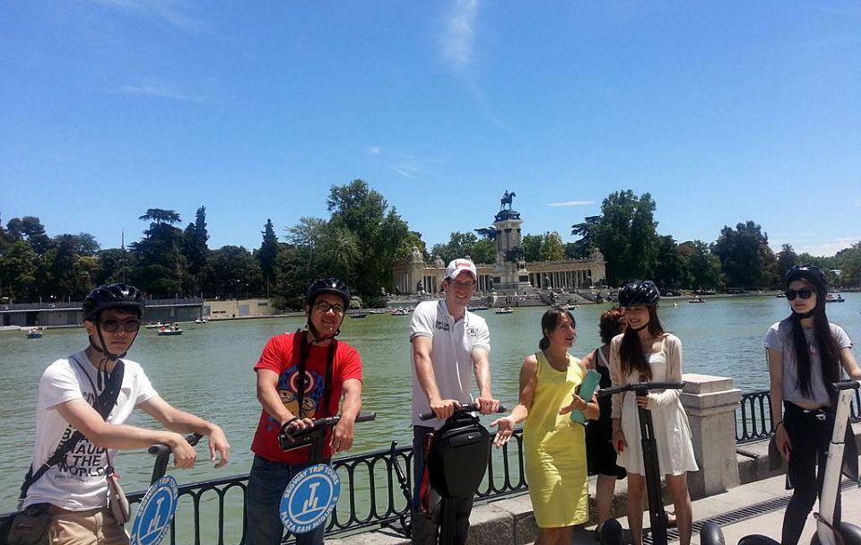 Madrid: Retiro Park 1.5-Hour Segway Tour - Entering Retiro Park: pond views, Crystal Palace, and dramatic statues